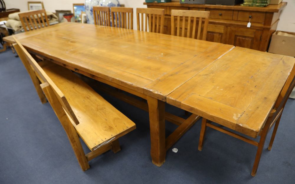 A French provincial dining suite, comprising a draw leaf table, six chairs, a bench, a sideboard and a buffet, table 350cm extended wid